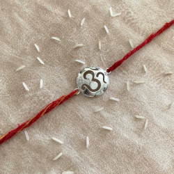 An Auspicious Silver OM Rakhi for Rakshabandhan With Red Thread For Brother
